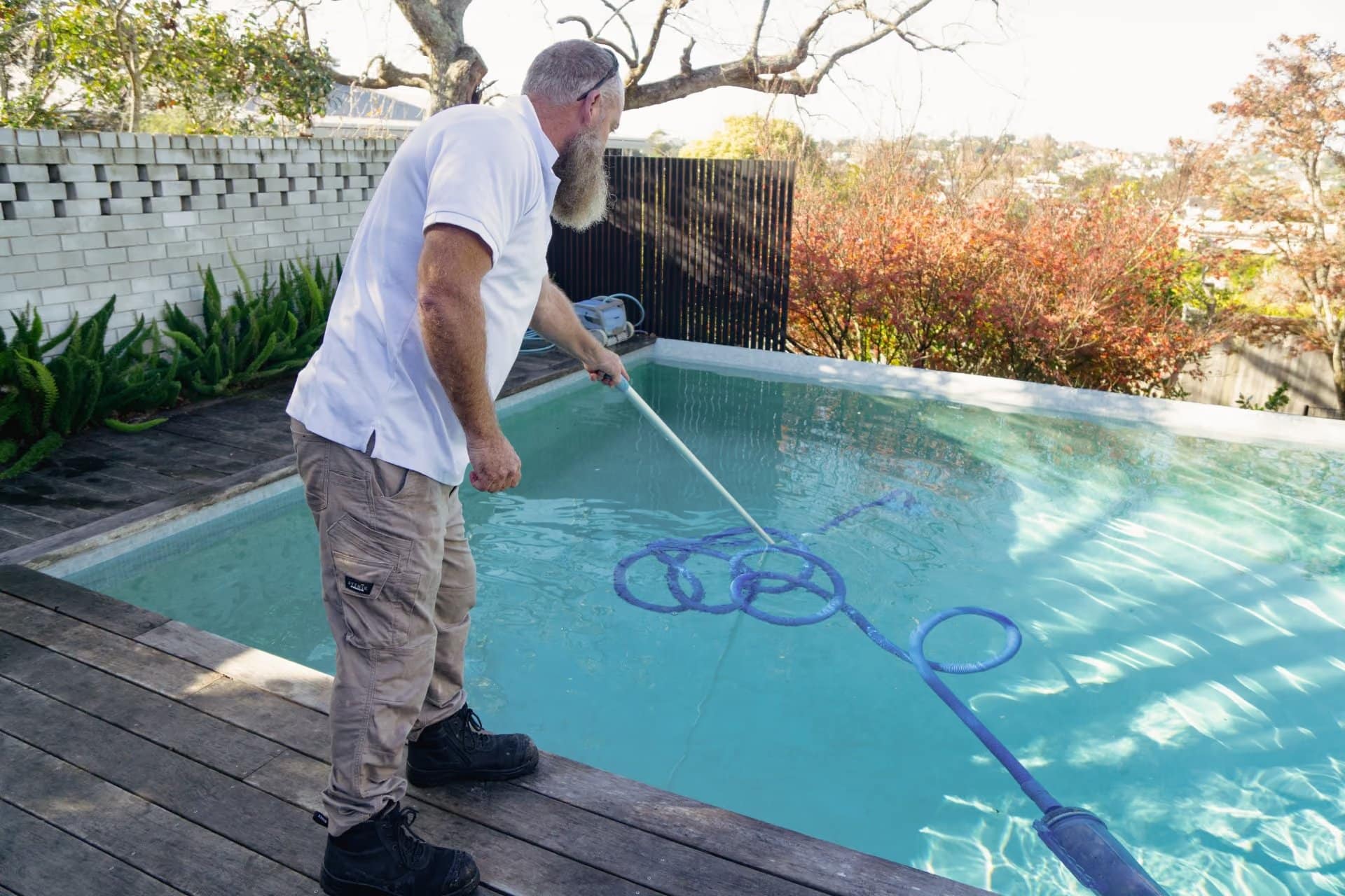 Sparkling Pools - technician vacuuming a pool in Auckland